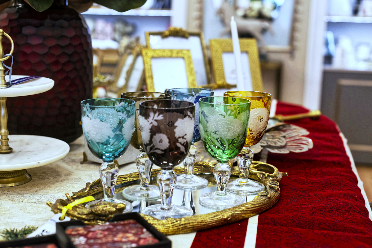 Pahare din cristal colorat gravat, pe o tava aurie, in magazinul Artinterior din Baneasa Shopping City
